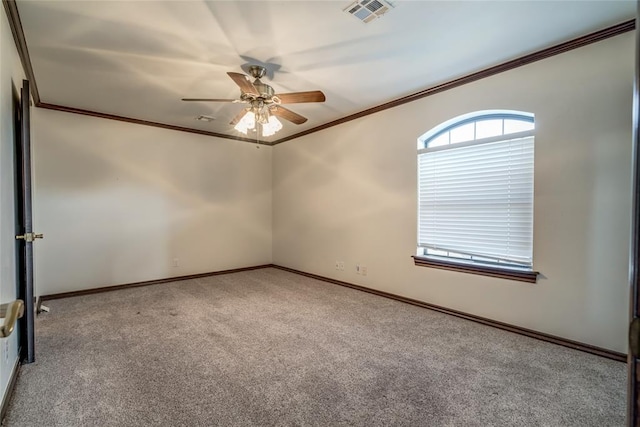 carpeted spare room featuring ceiling fan and ornamental molding