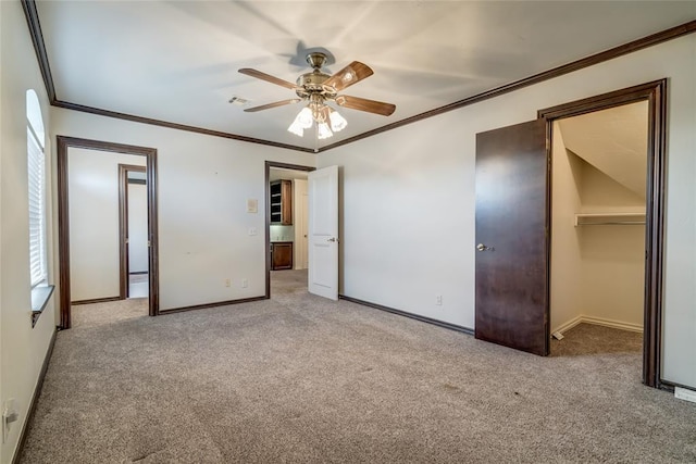 unfurnished bedroom with ceiling fan, light colored carpet, and crown molding