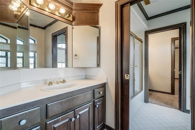 bathroom with shower / bath combination with glass door, crown molding, and vanity