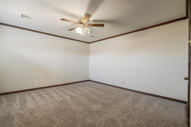 empty room featuring crown molding, carpet floors, and ceiling fan