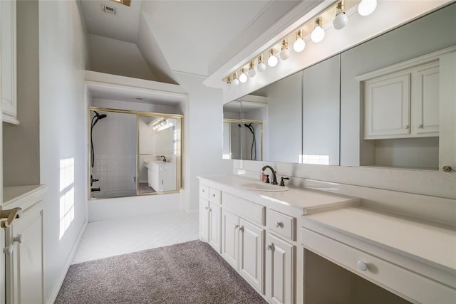 bathroom featuring vanity and combined bath / shower with glass door