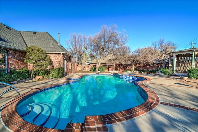 view of swimming pool with an in ground hot tub and a patio area