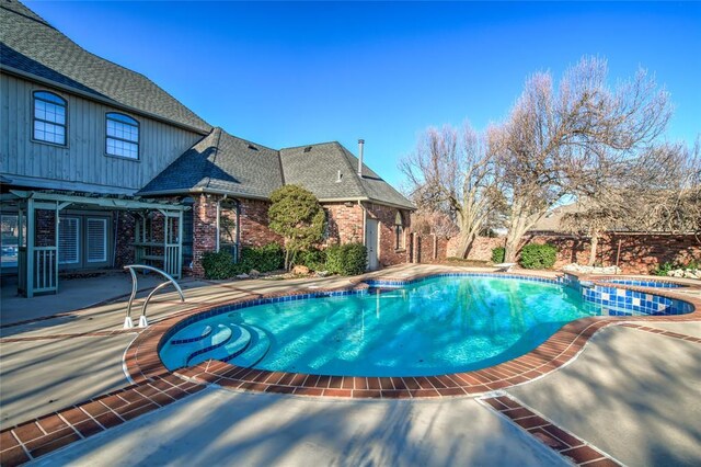 view of swimming pool with an in ground hot tub and a patio