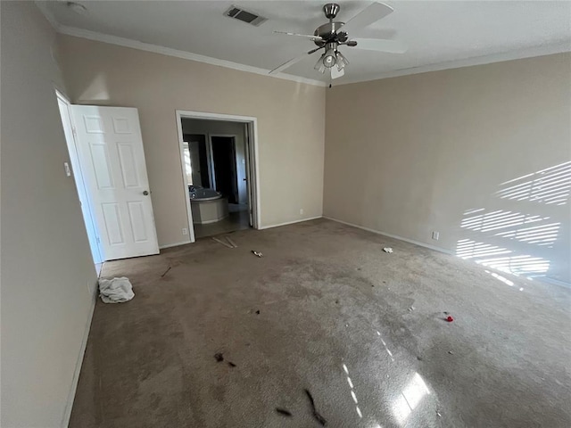 unfurnished bedroom featuring ceiling fan, crown molding, and ensuite bath