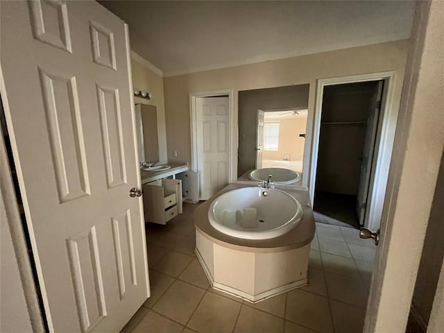 bathroom with ceiling fan, a bathtub, and tile patterned flooring