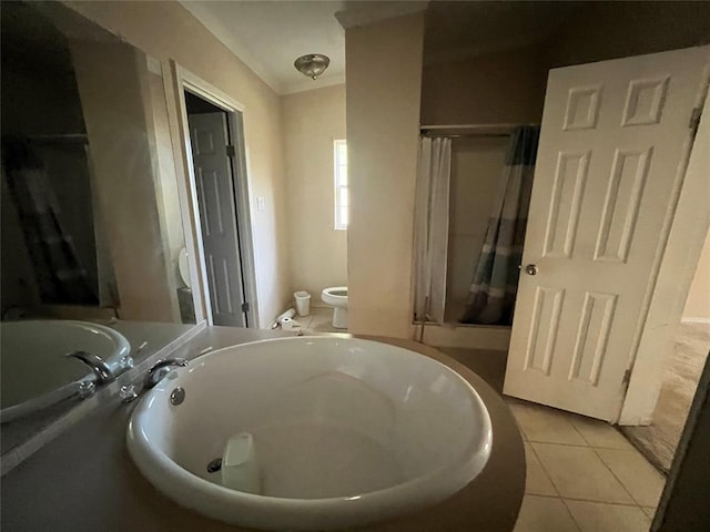 bathroom featuring tile patterned flooring, toilet, and a shower