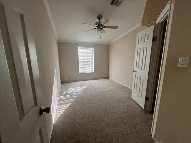 unfurnished room with ceiling fan, carpet, and ornamental molding