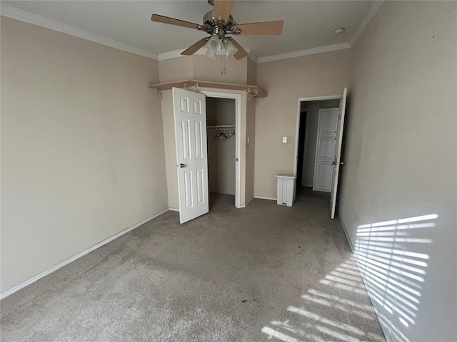 unfurnished bedroom featuring carpet flooring, a closet, ceiling fan, and crown molding