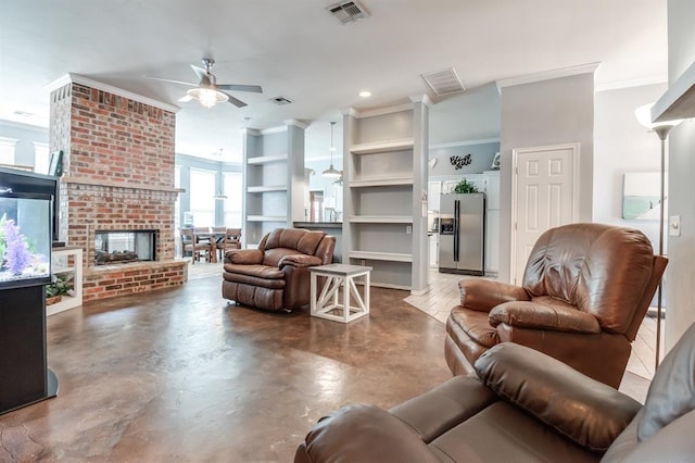 living room featuring ceiling fan, built in features, concrete floors, a fireplace, and ornamental molding