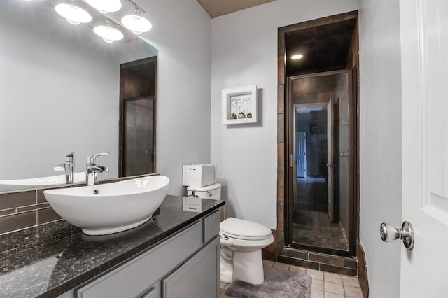 bathroom with toilet, vanity, and walk in shower