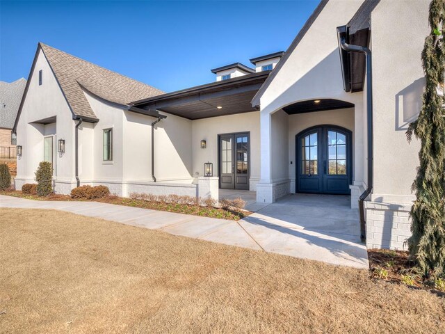 view of front facade featuring french doors and a front yard