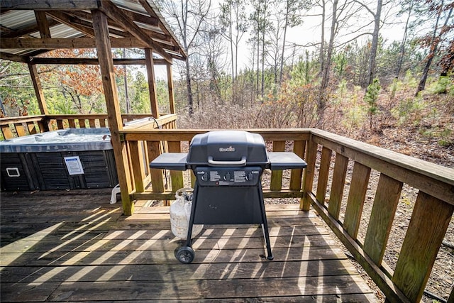 deck with area for grilling and a hot tub