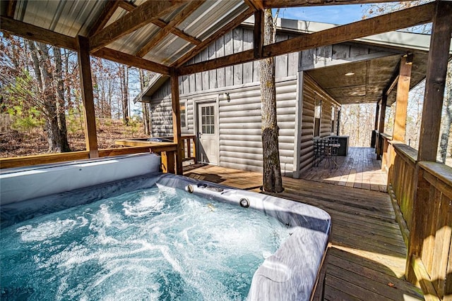 deck with an outdoor hot tub