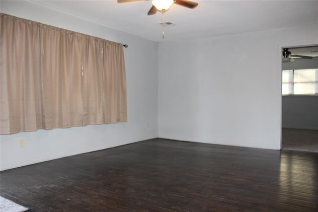 unfurnished room featuring ceiling fan and dark wood-type flooring