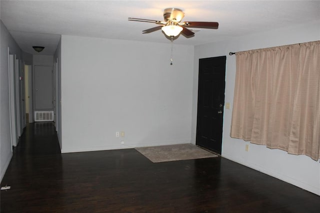 empty room with ceiling fan and dark hardwood / wood-style floors