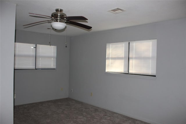 carpeted spare room with ceiling fan