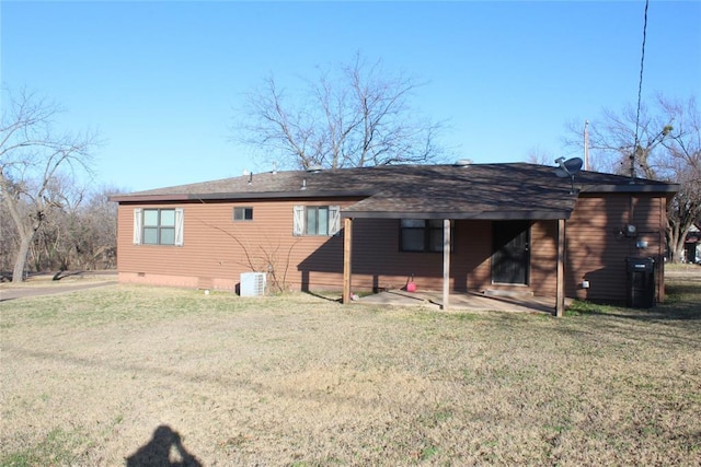 back of house with a lawn and a patio area