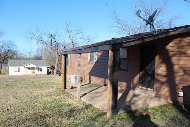 view of home's exterior with a lawn and a patio