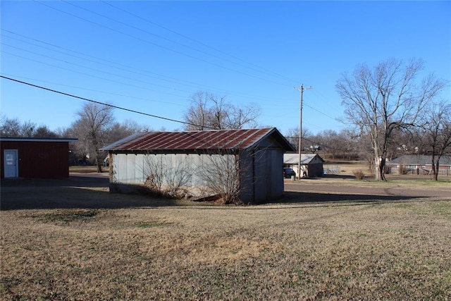 view of outbuilding featuring a lawn