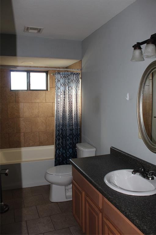 full bathroom featuring tile patterned floors, vanity, toilet, and shower / tub combo with curtain