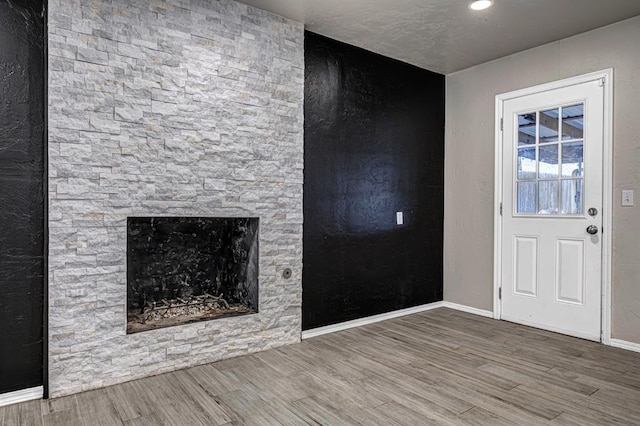 unfurnished living room with a fireplace and hardwood / wood-style floors