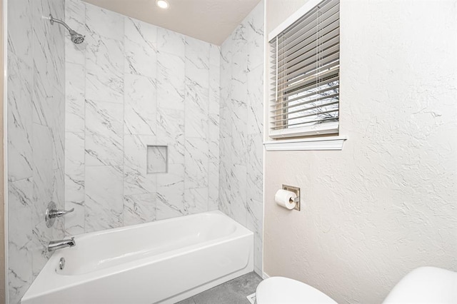 bathroom with shower / tub combination, toilet, and tile patterned floors