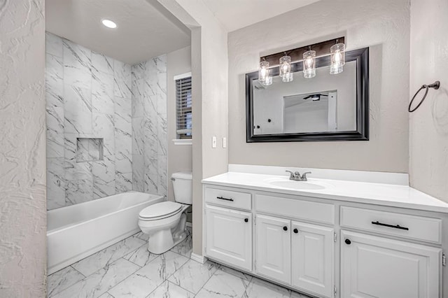 full bathroom with vanity, tiled shower / bath combo, and toilet