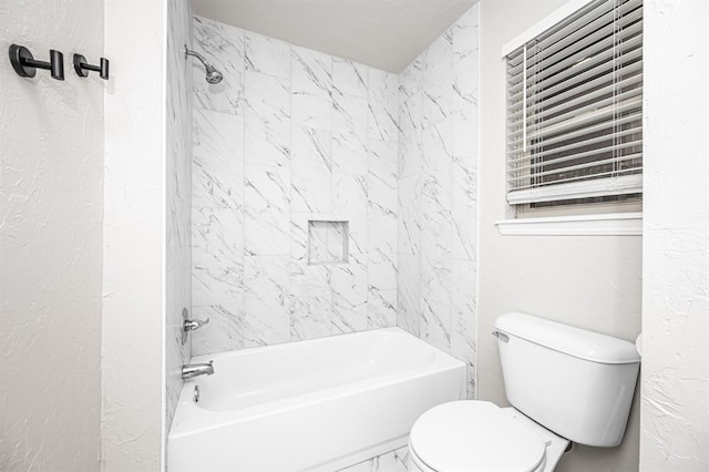 bathroom featuring shower / bathtub combination and toilet