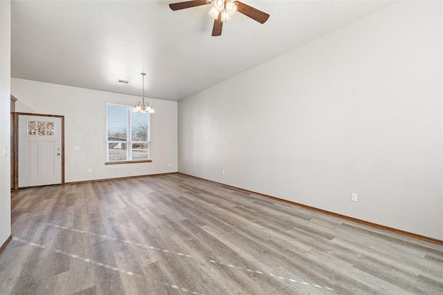 unfurnished room featuring ceiling fan with notable chandelier