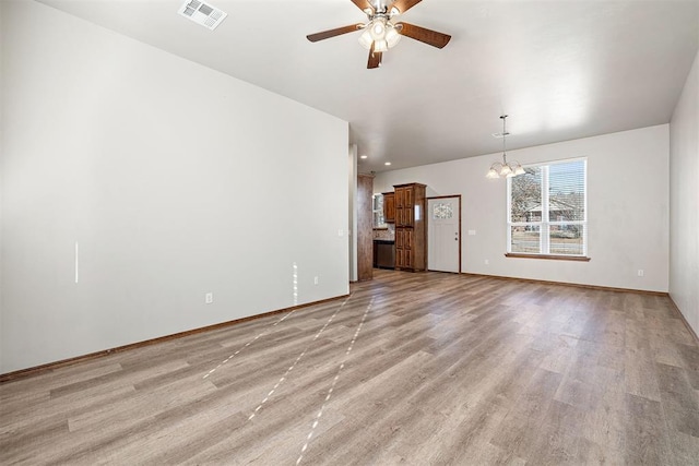 unfurnished living room featuring light wood-type flooring and ceiling fan with notable chandelier