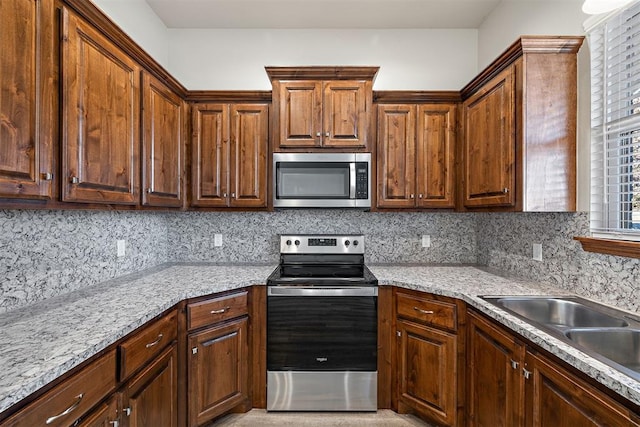 kitchen featuring backsplash, stainless steel appliances, and sink