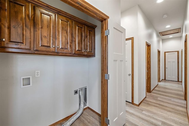 washroom featuring hookup for an electric dryer, light hardwood / wood-style floors, cabinets, and washer hookup