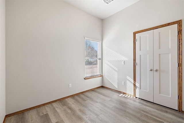 unfurnished room with light hardwood / wood-style flooring