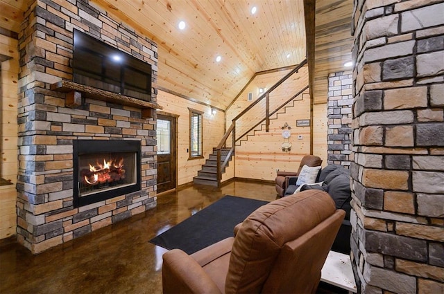 unfurnished living room with high vaulted ceiling, wood walls, concrete flooring, a fireplace, and wood ceiling