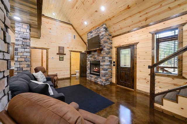 living room featuring high vaulted ceiling, a stone fireplace, wood ceiling, and wooden walls