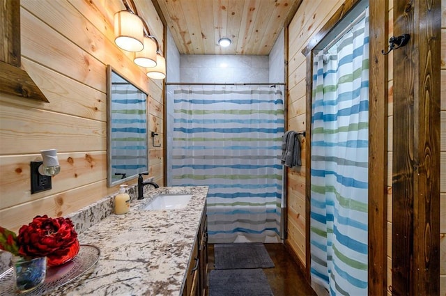 bathroom with vanity, wood ceiling, and wood walls