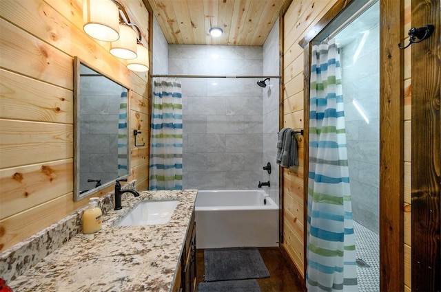 bathroom featuring vanity, wood walls, and shower / bathtub combination with curtain