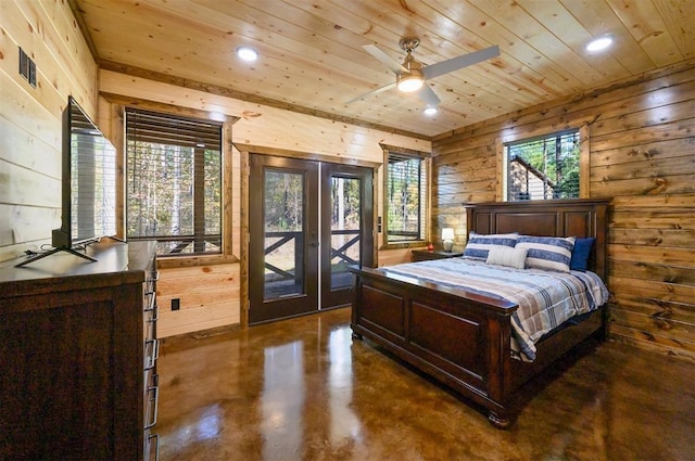 bedroom with ceiling fan, wooden ceiling, access to outside, multiple windows, and wooden walls