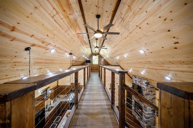 hall with wooden walls, sink, wooden ceiling, and vaulted ceiling