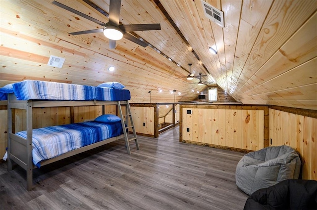 bedroom featuring dark hardwood / wood-style floors, wooden ceiling, wooden walls, and lofted ceiling