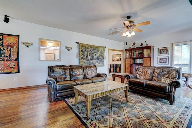 living room featuring ceiling fan and wood-type flooring