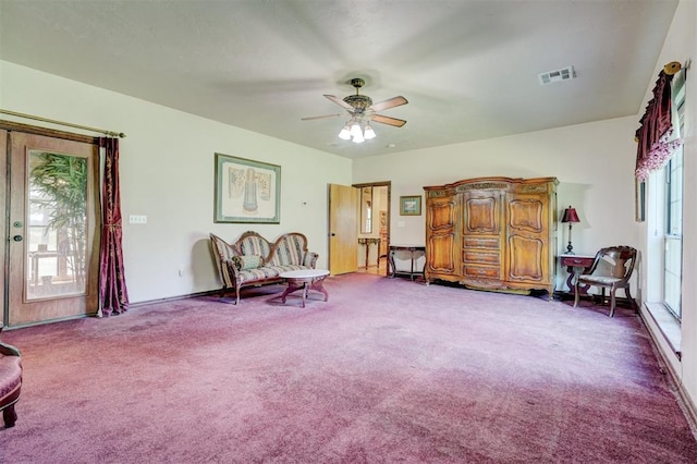 sitting room with carpet floors, ceiling fan, and a healthy amount of sunlight