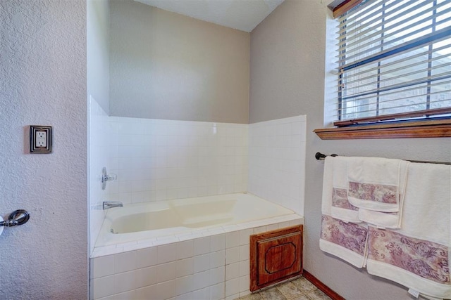 bathroom with a relaxing tiled tub