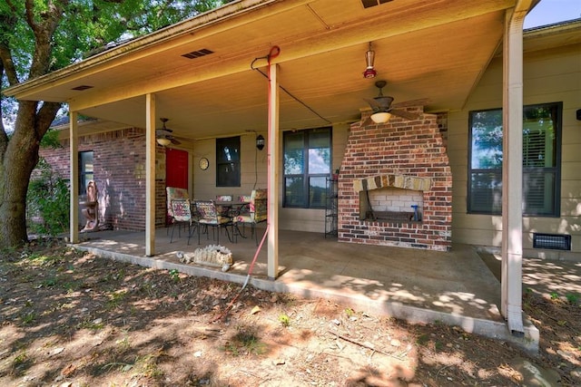 view of patio / terrace featuring an outdoor brick fireplace and ceiling fan