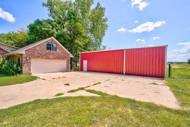 view of gate featuring a yard and an outdoor structure