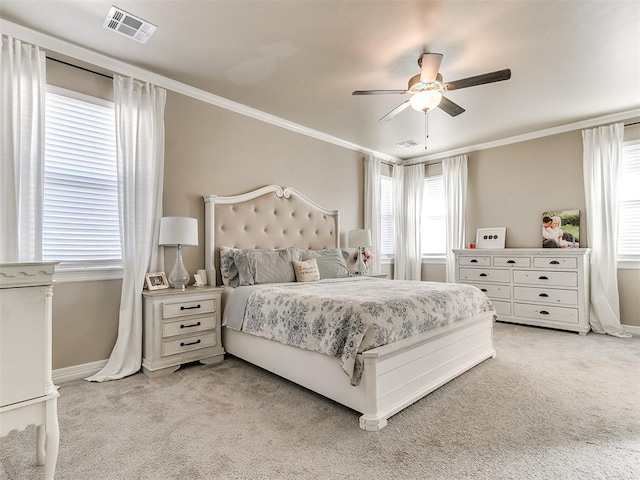 bedroom featuring ceiling fan, ornamental molding, and light carpet