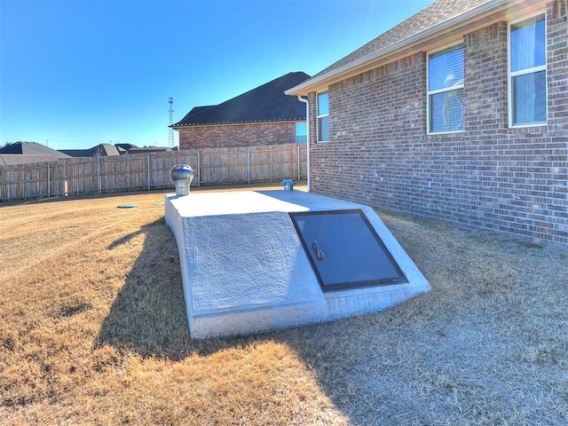 view of storm shelter with a lawn