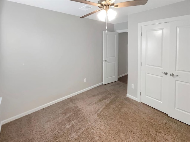 unfurnished bedroom with light carpet, a closet, and ceiling fan