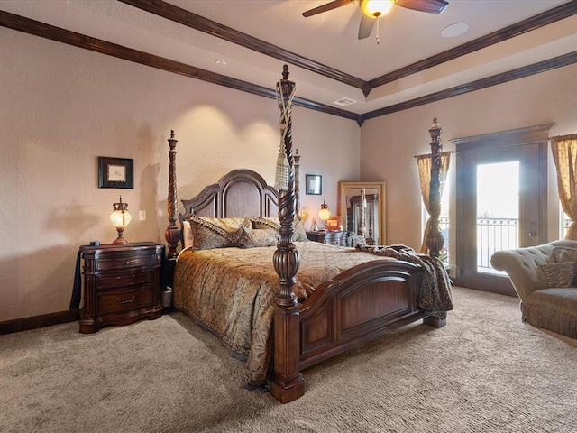 bedroom with a tray ceiling, ornamental molding, ceiling fan, and carpet flooring