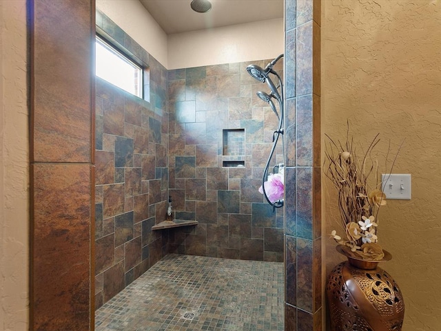 bathroom with tiled shower